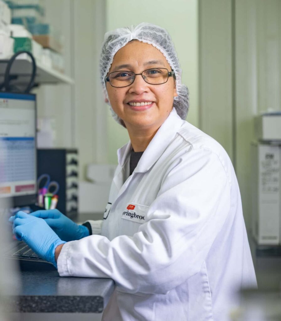 Springbrook Foods team member conducting quality testing in on-site laboratory.