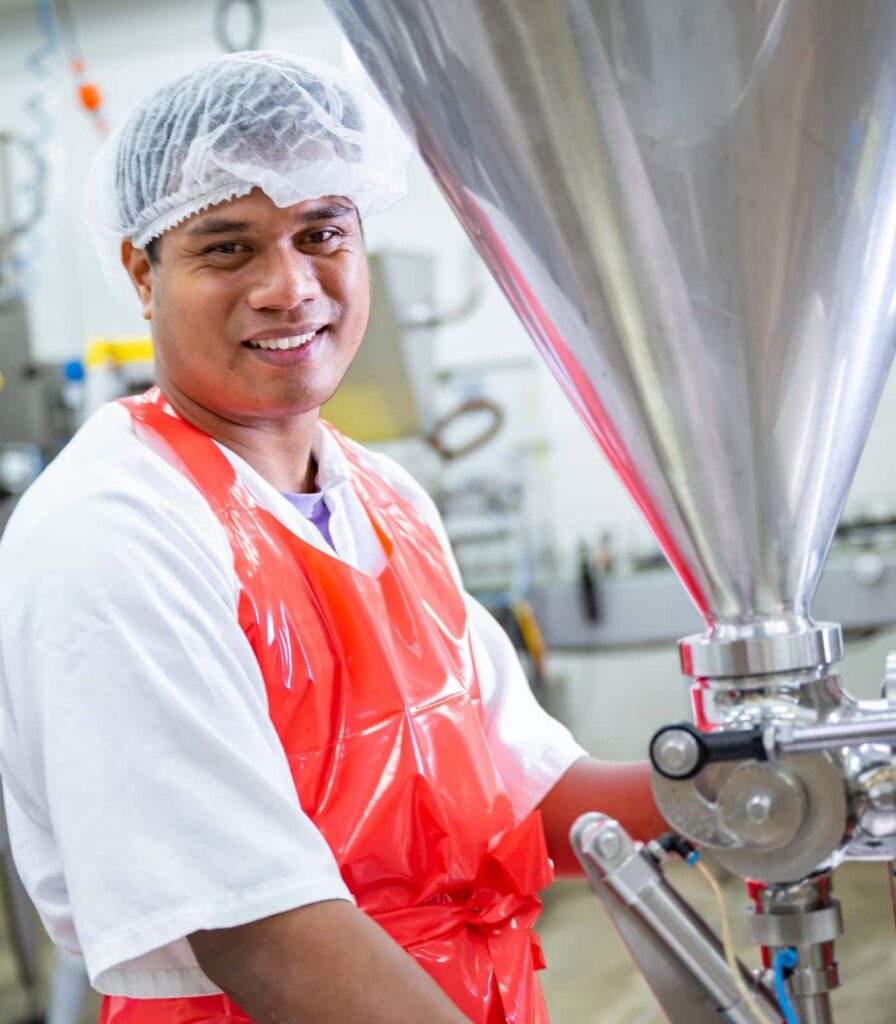 Springbrook Foods team member operating sauce filling equipment