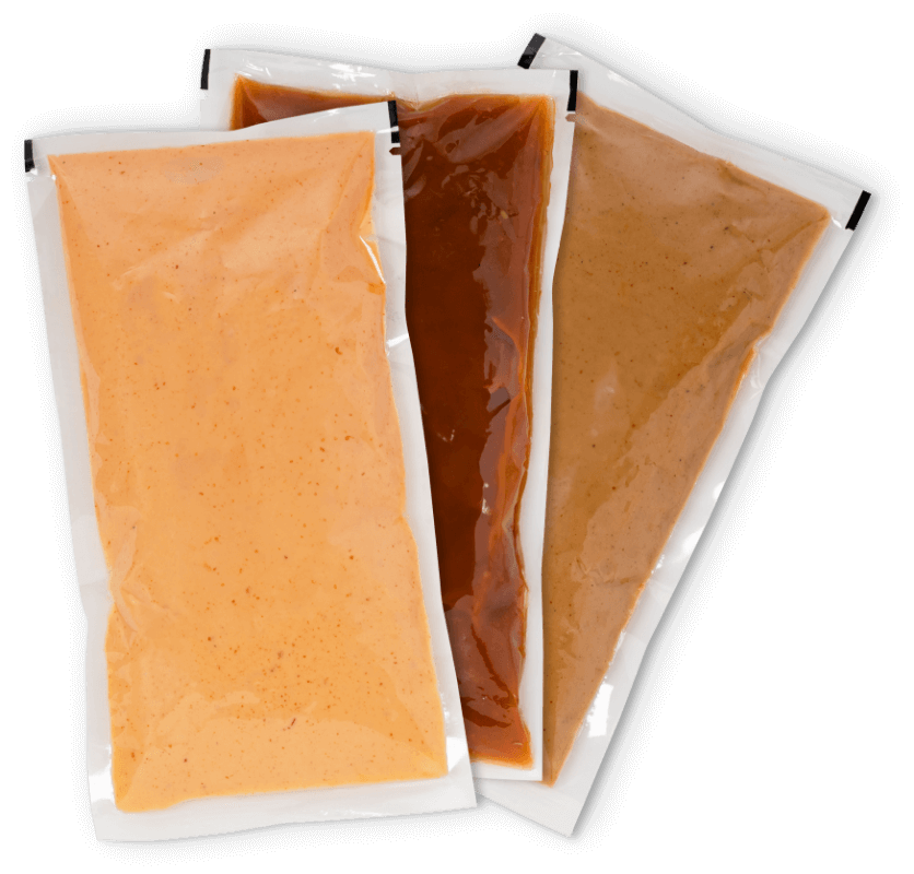 Bulk and single-serve sauce sachets showcasing flexible food packaging solutions.