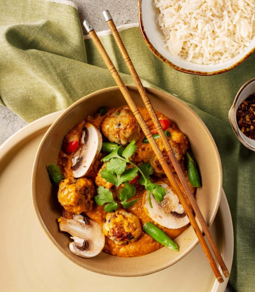 Prepared meal featuring sauce and fresh ingredients showcasing food manufacturing solutions.