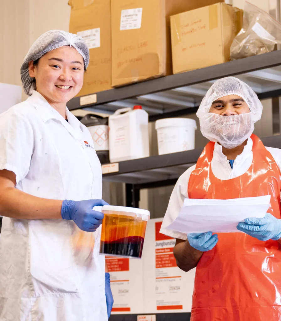 Springbrook team members reviewing sauce batch during food manufacturing process